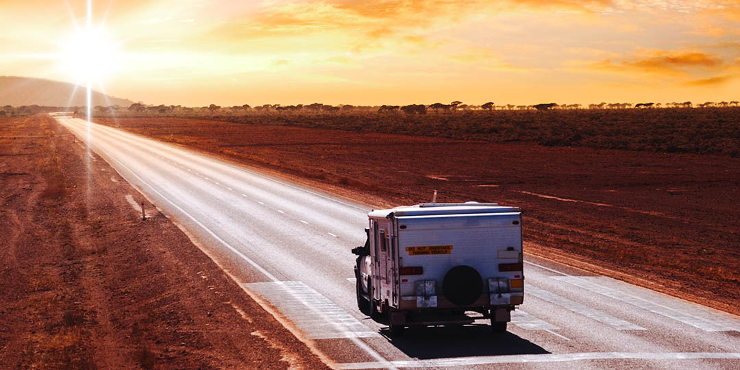 Australian Outback Touring Caravan on arbor Plain Road at Sunrise