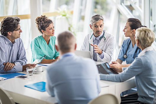 Physicians discussing around a table