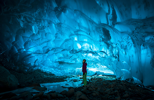 Looking inside blue ice cave in Canada