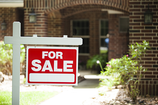 For Sale sign in front of house