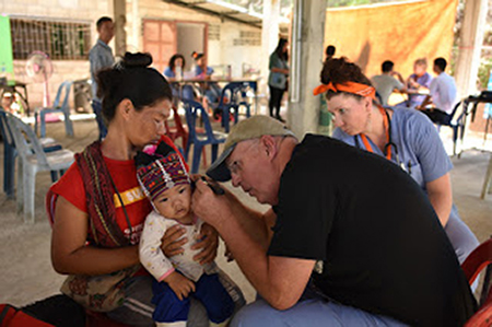 Doctor treating patient on a medical mission