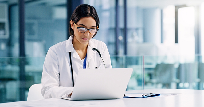 PHysician at laptop computer