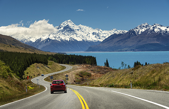 Red car on the road to Mt.Cook,New Zealand