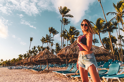 Woman in cutoffs on the beach of a caribbean island