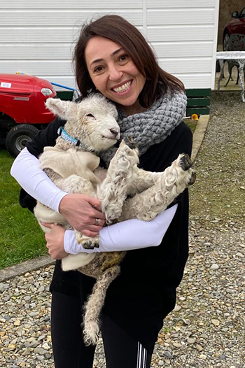 Dr. Restrepo holding a lamb