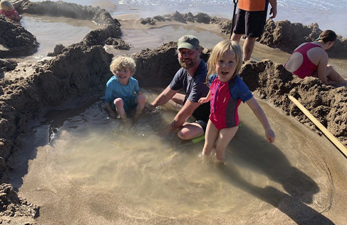 Dr Parrish's husband and daughters on NZ beach