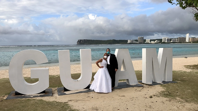 Drs Holly and Paul Llobet on beach in Guam