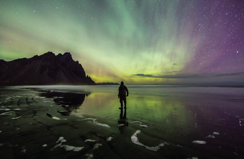 picture of person looking at Northern Lights in Alaska