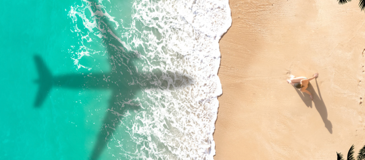 A plane flying over a beach